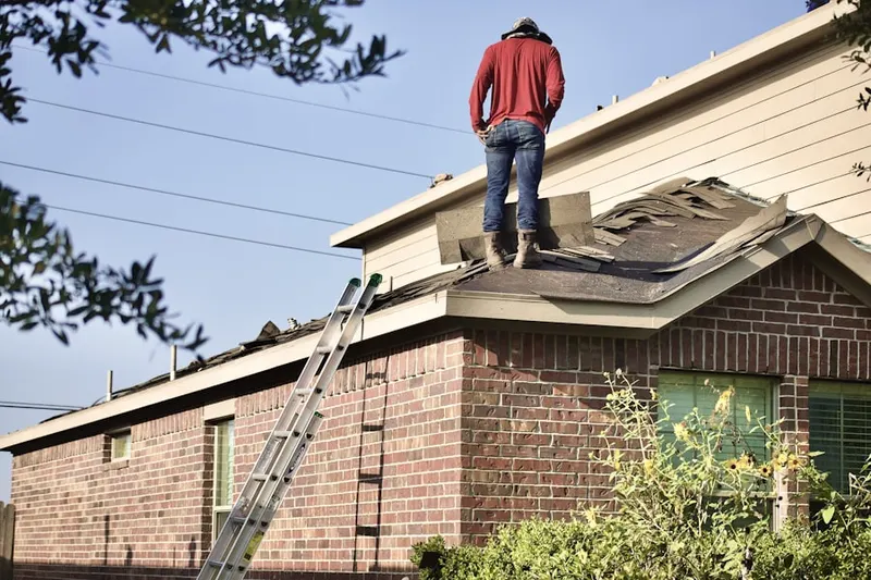 Professional roofer working on a residential roof in Mashpee
